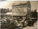 Black and white photo of people in front of old building