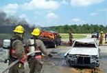 Firefighters Practicing Extinguishing a Car Fire