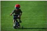 Child riding a bicycle with training wheels